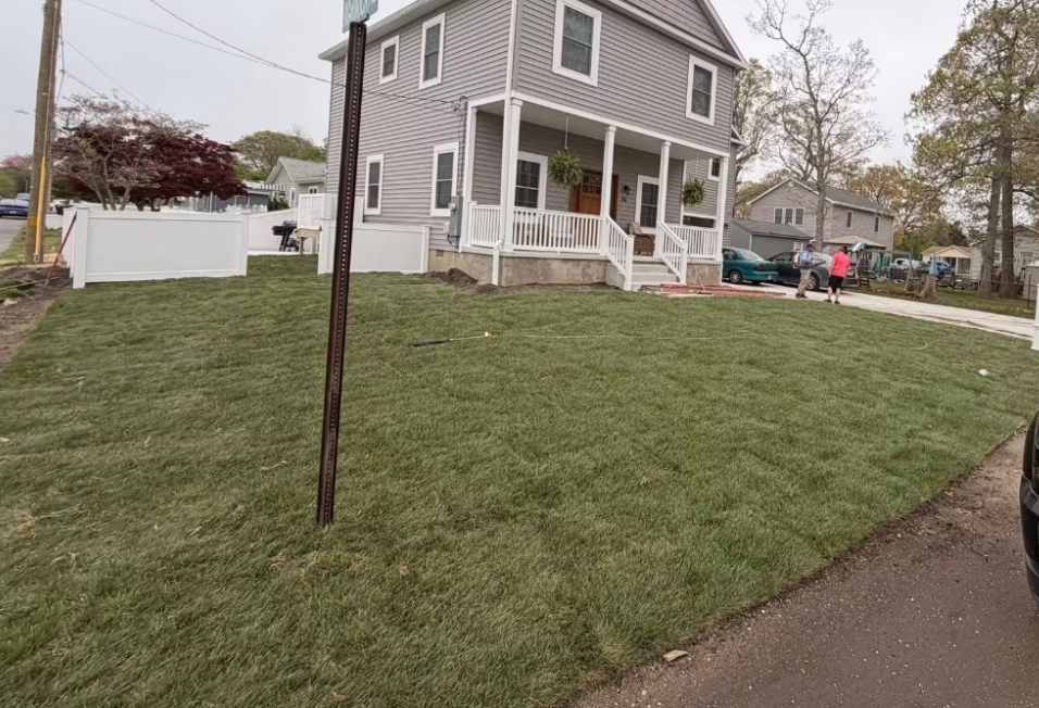 Lush green sod lawn on the same front yard after installation