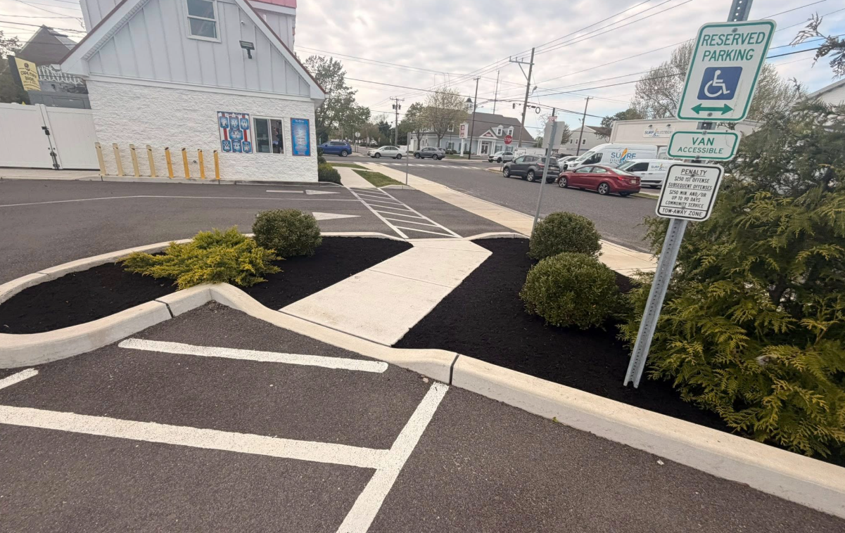 Commercial parking lot landscaping with shrubs and mulch